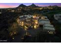 Twilight aerial view of the estate with a unique architectural design and mountain views at 10801 E Happy Valley Rd # 102, Scottsdale, AZ 85255