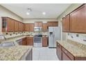 Kitchen features granite countertops and modern cabinetry at 10813 W Saddlehorn Rd, Peoria, AZ 85383