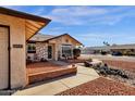 House exterior showcasing a stone facade and brick walkway at 10837 S Shoshoni Dr, Phoenix, AZ 85044