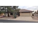 Single-story house with a two-car garage and desert landscaping at 12721 W Allegro Dr, Sun City West, AZ 85375