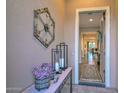 Elegant foyer with stylish decor, including a console table with flowers and artwork, creating a welcoming ambiance at 12780 W Desert Vista Trl, Peoria, AZ 85383