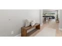 Modern entryway with wood bench, light walls, and view to living room at 1950 W Desert Hollow Dr, Phoenix, AZ 85085