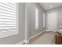 Bright entryway with wood bench, light walls, and plantation shutters at 1950 W Desert Hollow Dr, Phoenix, AZ 85085