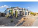 Modern home with a clean design and a large front yard with desert landscaping at 2038 E Dry Wood Rd, Phoenix, AZ 85024