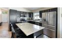 Modern kitchen with stainless steel appliances, a center island, and dark cabinetry at 2234 E Stephens Rd, Gilbert, AZ 85296