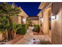 Well-lit walkway and lush landscaping create a welcoming entrance at 22819 N Del Monte Dr, Sun City West, AZ 85375