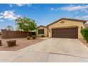 Single story home with a spacious driveway, desert landscaping, and a block wall at 2364 S Minneola Ln, Gilbert, AZ 85295