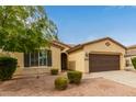 Attractive single-story home with desert landscaping and a brown two-car garage at 2364 S Minneola Ln, Gilbert, AZ 85295