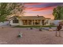 Covered patio, grassy area, and gravel landscaping at 23833 S Stoney Path Dr, Sun Lakes, AZ 85248