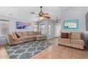 Bright living room featuring a sectional sofa and tile floors at 29127 N Mountain View Rd, San Tan Valley, AZ 85143