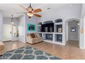 Living room with built-in shelving and a large TV at 29127 N Mountain View Rd, San Tan Valley, AZ 85143