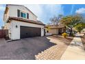 Two-story house with a driveway and sidewalk, located on a quiet street at 3057 E Trigger Way, Gilbert, AZ 85297