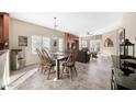 Bright dining area with a wooden table and chairs, open to the living room at 307 E Cheyenne Rd, San Tan Valley, AZ 85143