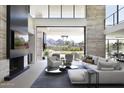 Bright and airy living room with fireplace, stylish decor, and seamless indoor-outdoor flow at 4451 E Joshua Tree Ln, Paradise Valley, AZ 85253