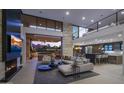 Open-concept living room with fireplace, modern furniture, and picturesque outdoor views at 4451 E Joshua Tree Ln, Paradise Valley, AZ 85253