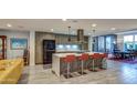 Bright kitchen with stainless appliances, sleek countertops, and seating at island at 5674 N 12Th St, Phoenix, AZ 85014