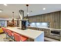 Modern kitchen with long island, stainless appliances, barstool seating and pendant lights at 5674 N 12Th St, Phoenix, AZ 85014