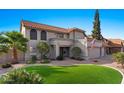 Two-story house with tile roof, attached garage, and manicured lawn at 5859 E Elmwood E St, Mesa, AZ 85205