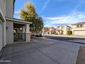 Street view of the home featuring well-maintained landscaping, a covered porch, and a two car garage at 6455 W Orchid Ln, Glendale, AZ 85302