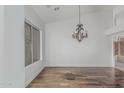 Elegant dining room with hardwood floors and a decorative chandelier at 7735 E Russell Cir, Mesa, AZ 85207