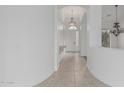 Bright hallway with arched entry and decorative console table at 7735 E Russell Cir, Mesa, AZ 85207