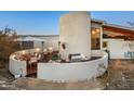 Outdoor patio with built-in grill and seating area at 7915 E Primrose Path, Carefree, AZ 85377