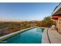 Luxury pool with mountain views and desert landscape at 7915 E Primrose Path, Carefree, AZ 85377