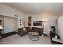 Living room with gray sectional sofa, coffee table, and large artwork at 9707 E Mountain View Rd # 2430, Scottsdale, AZ 85258