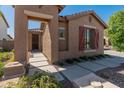 Charming front entrance with a covered walkway and desert landscaping at 12541 W Miner Trl, Peoria, AZ 85383