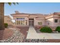 Front entry of the house with a walkway and desert landscaping at 15111 W Whitewood Dr, Sun City West, AZ 85375