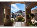 View through the front entrance showcasing a neighboring house and desert landscape at 1626 E Kathleen Rd, Phoenix, AZ 85022