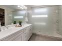 Bathroom with white cabinets and a large walk-in shower at 18402 N 65Th Pl, Phoenix, AZ 85054