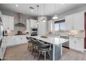 Spacious kitchen featuring white cabinets and a large island at 18402 N 65Th Pl, Phoenix, AZ 85054