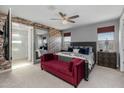 Main bedroom with a brick accent wall and a large bed at 18402 N 65Th Pl, Phoenix, AZ 85054