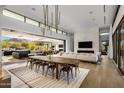 Open concept dining room with a large table and modern lighting at 27951 N 96Th Pl, Scottsdale, AZ 85262