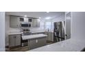 Charming kitchen features stainless steel appliances and white stone countertops with an island at 3104 E Broadway Rd # 16, Mesa, AZ 85204