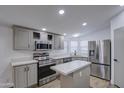Charming kitchen features stainless steel appliances and white stone countertops with an island at 3104 E Broadway Rd # 16, Mesa, AZ 85204