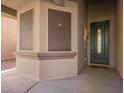 Front entry with a dark teal door and screened windows at 4337 W Powell Dr, Phoenix, AZ 85087