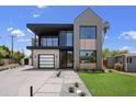 Attractive modern home with a combination of gray and white brick, two stories and manicured landscaping at 4445 E Roma Ave, Phoenix, AZ 85018