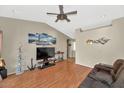 Bright living room featuring wood floors, vaulted ceiling, ceiling fan, and nautical decor at 8418 W Almeria Rd, Phoenix, AZ 85037