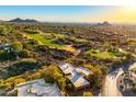 Expansive aerial view of a desert home situated near a lush green golf course with mountain views at 1084 N Boulder Dr, Carefree, AZ 85377