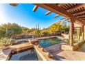 Exterior shot of property, featuring a pool with desert landscaping and mountain views at 1084 N Boulder Dr, Carefree, AZ 85377