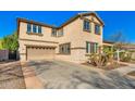 Charming two-story home featuring a desert landscape, covered porch, and well maintained driveway at 11866 N 143Rd Ave, Surprise, AZ 85379