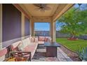 Relaxing covered patio with comfortable seating, a ceiling fan, and views of the yard at 12017 W Monte Lindo Ln, Sun City, AZ 85373