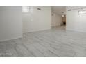 Open-concept floor plan with tile floors and a glimpse of a fireplace at 1225 E San Angelo Ave, Gilbert, AZ 85234