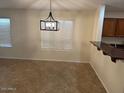Bright dining area featuring a modern pendant light and large windows at 12848 W Desert Mirage Dr, Peoria, AZ 85383
