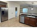 Modern kitchen with stainless steel appliances, sleek countertops, and a breakfast bar at 12848 W Desert Mirage Dr, Peoria, AZ 85383