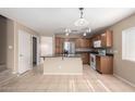 Charming kitchen with wooden cabinets, stainless steel appliances, and a center island for meal preparation at 1370 S 228Th Ln, Buckeye, AZ 85326