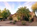Tan house with tile roof, two-car garage, and desert landscaping at 13830 W Fargo Dr, Surprise, AZ 85374