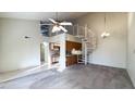 Open living area features a spiral staircase adjacent to the kitchen, under high ceilings at 1440 N Idaho Rd # 1008, Apache Junction, AZ 85119